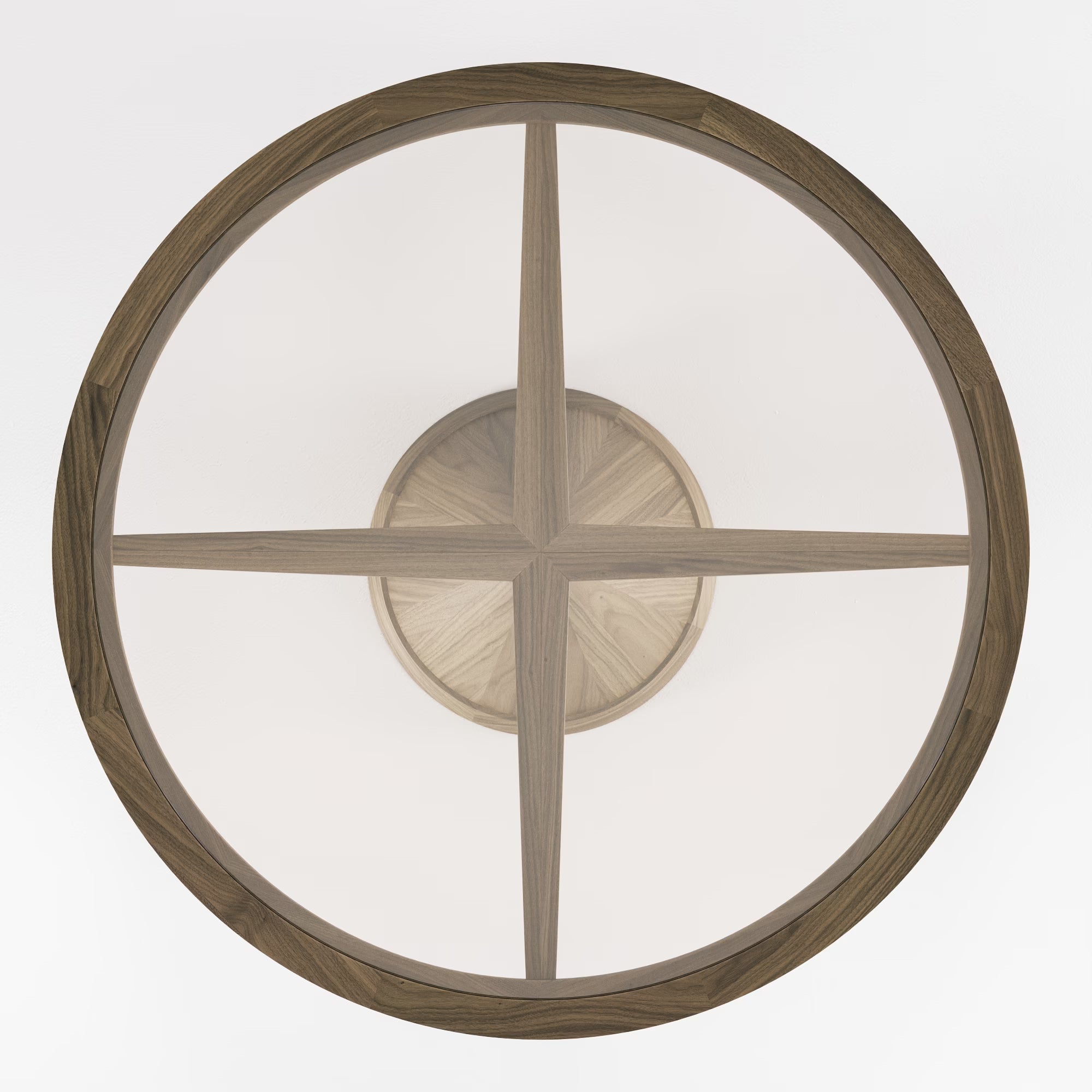 Table ronde Vasco en noyer et verre transparent, vue du dessus sur fond blanc, structure en croix apparente