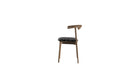 Chaise Pala de WeWood en noyer massif et tissu graphique noir, vue de côté sur fond blanc