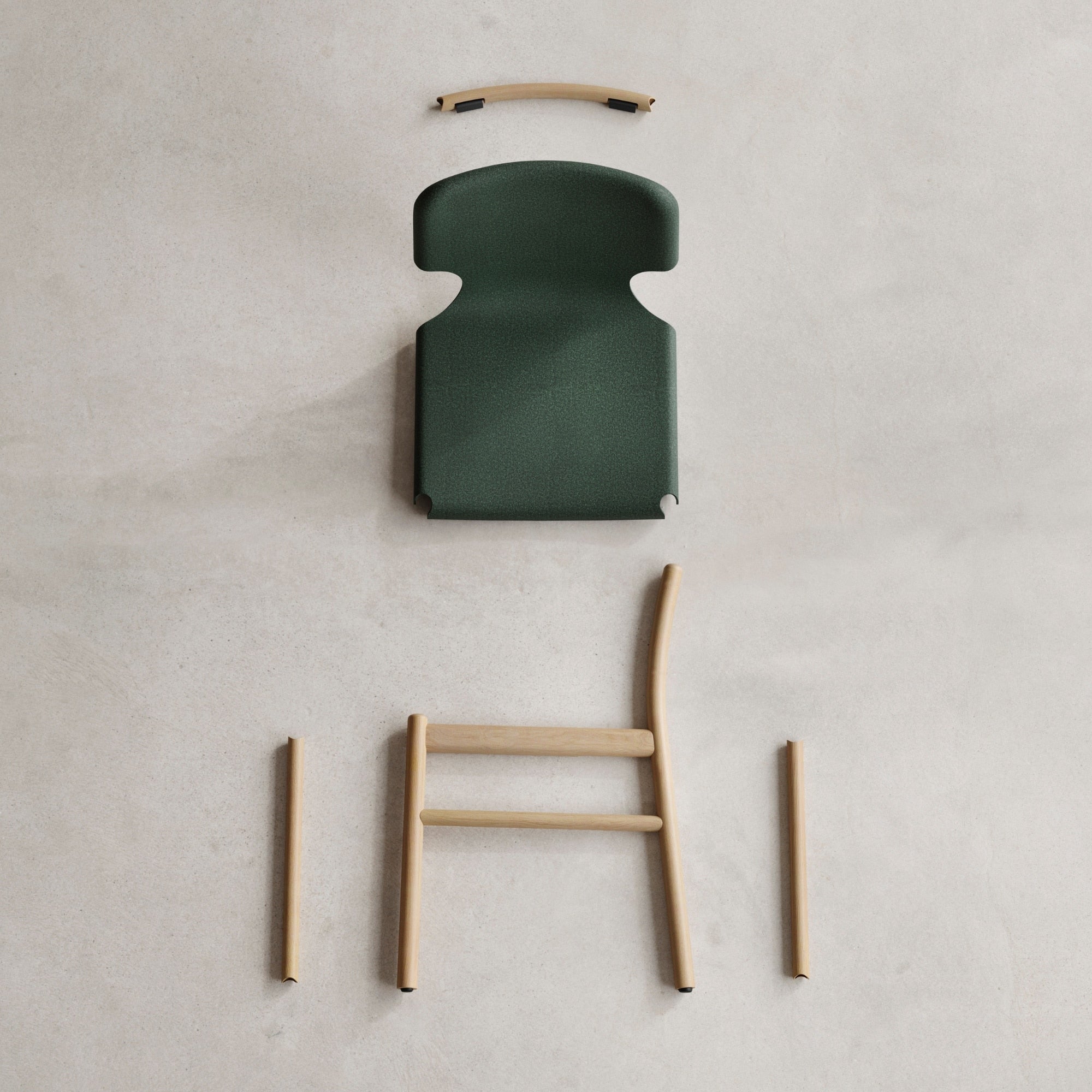 Éclaté de la chaise Xume d’Alki, avec assise verte et structure en bois clair démontée, vue de dessus