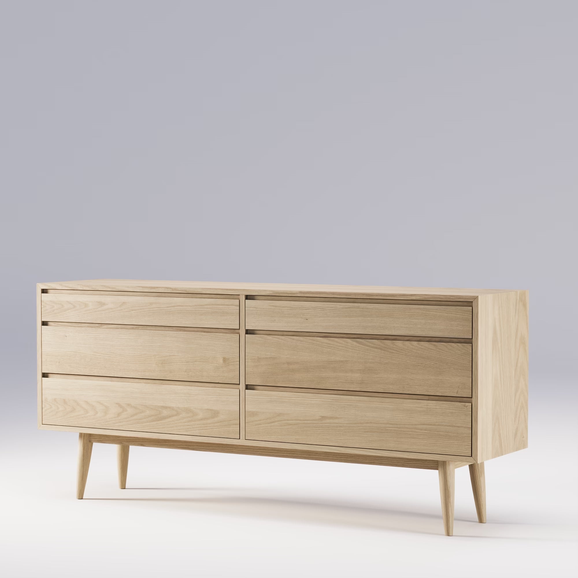 Commode Double de Wewood en chêne clair, vue en angle, six tiroirs sans poignées, piètement bois, fond gris clair dégradé
