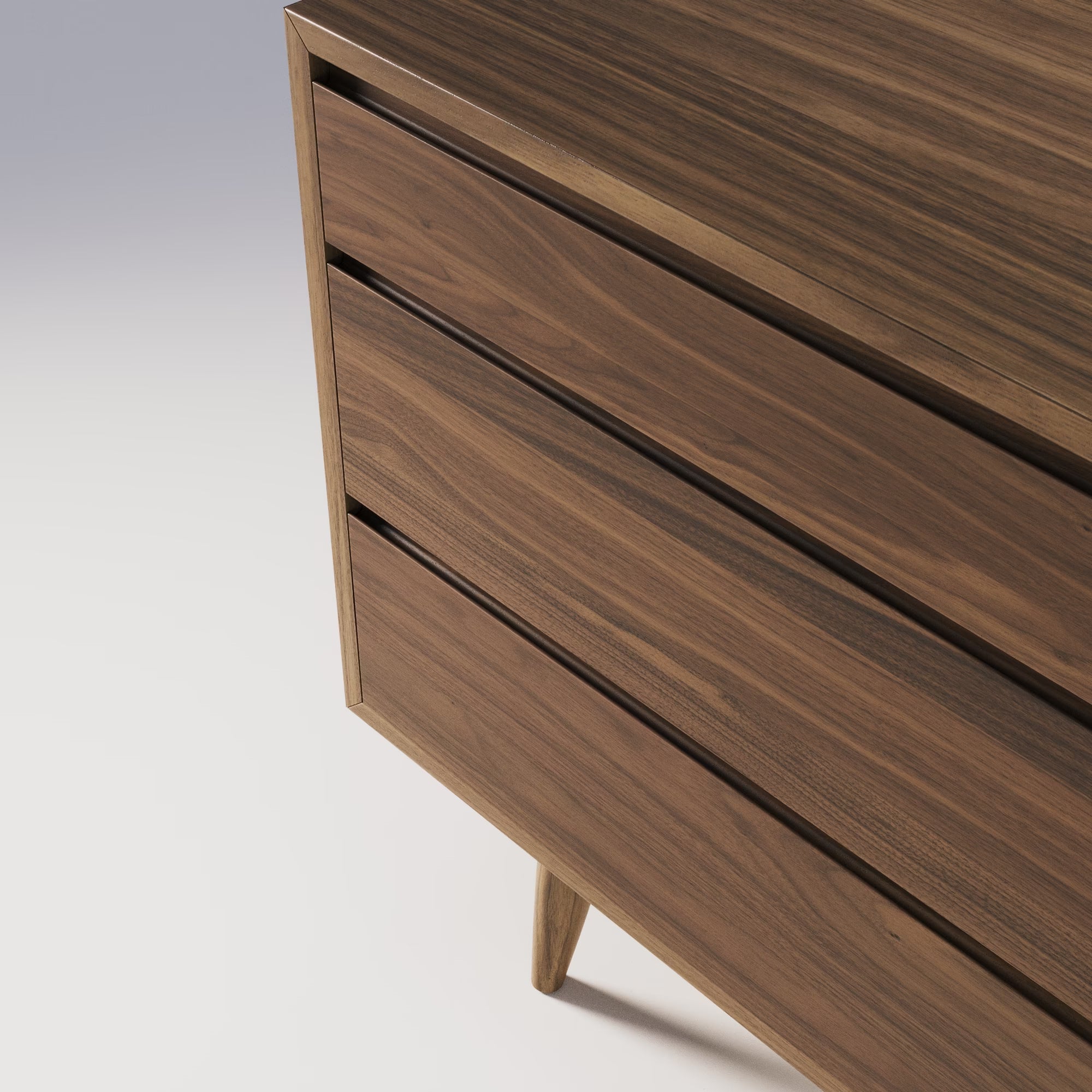 Zoom sur la commode Double Wewood en noyer, détail des tiroirs sans poignées et du veinage du bois, vue de trois quarts bas
