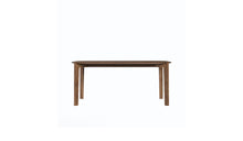 Vue de face de la table Soma 180 cm en noyer massif, piètement large et structure visible, 6 à 8 places, sur fond blanc