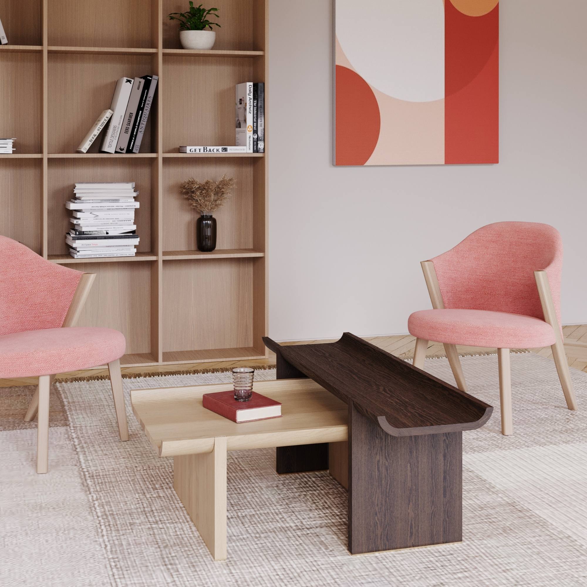 Coin lecture cosy avec fauteuils rose, étagère bois, tableau graphique et lumière douce sur tapis tissé.